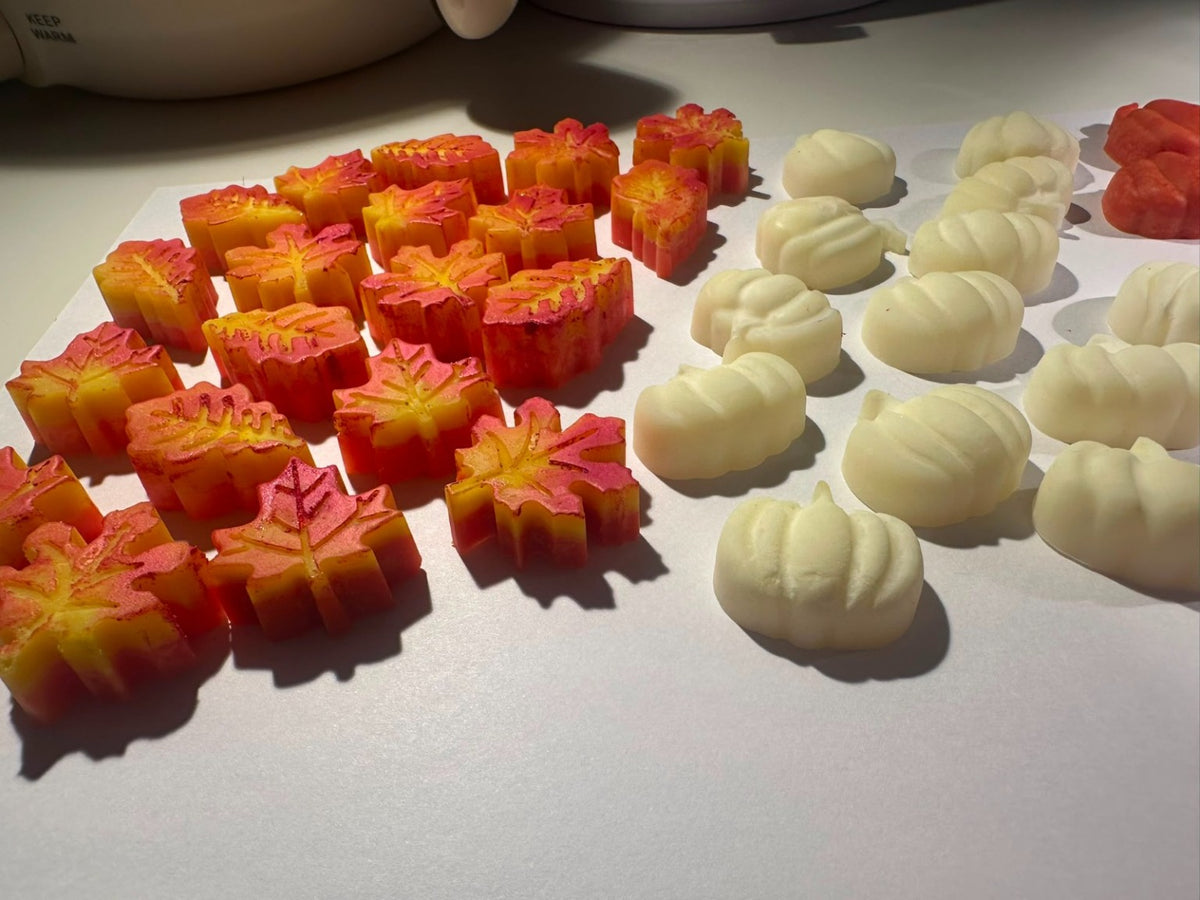 Handmade autumn leaf and white pumpkin wax decorations used on Cosy Fireplace candles