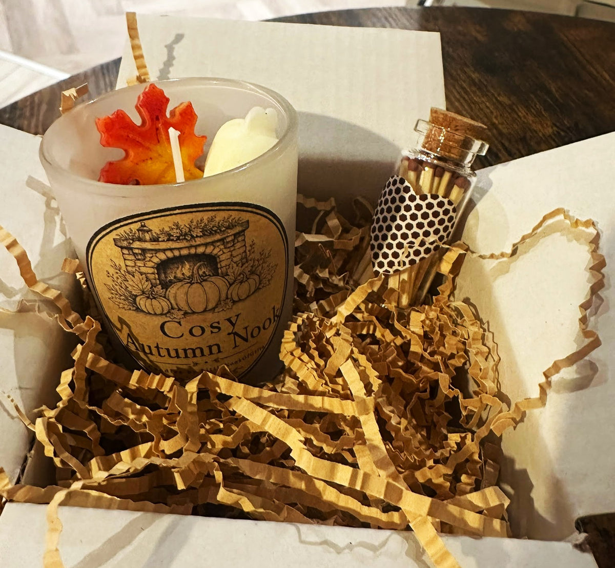 Cosy Fireplace autumn candle in open gift box with bottle of matches