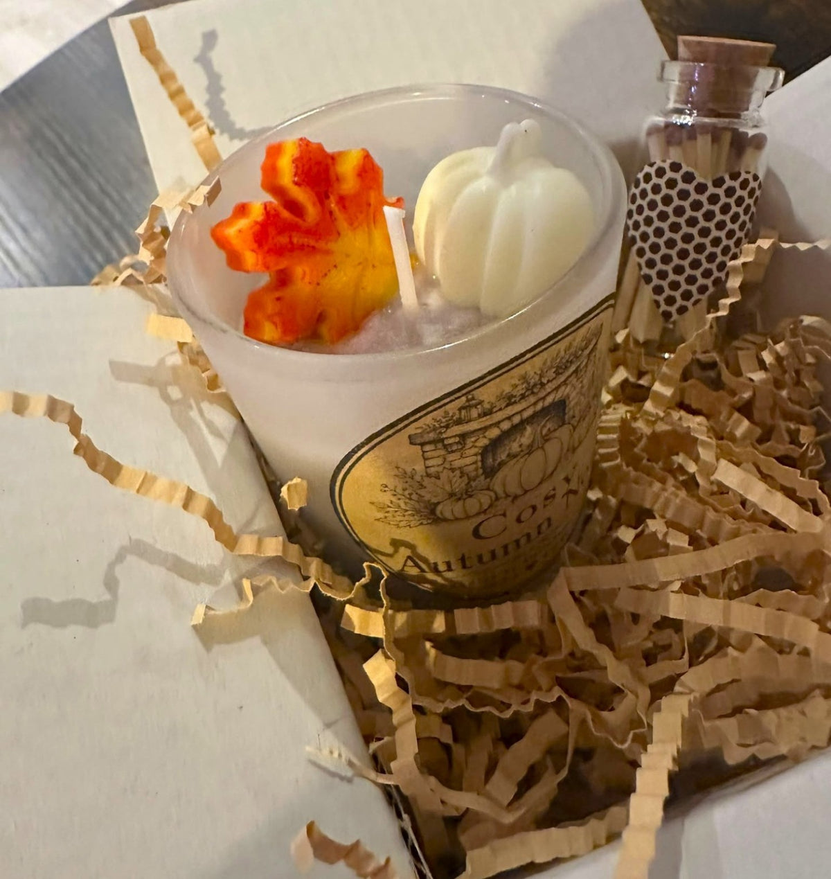 Cosy Fireplace candle with white pumpkin and orange autumn leaf wax decorations