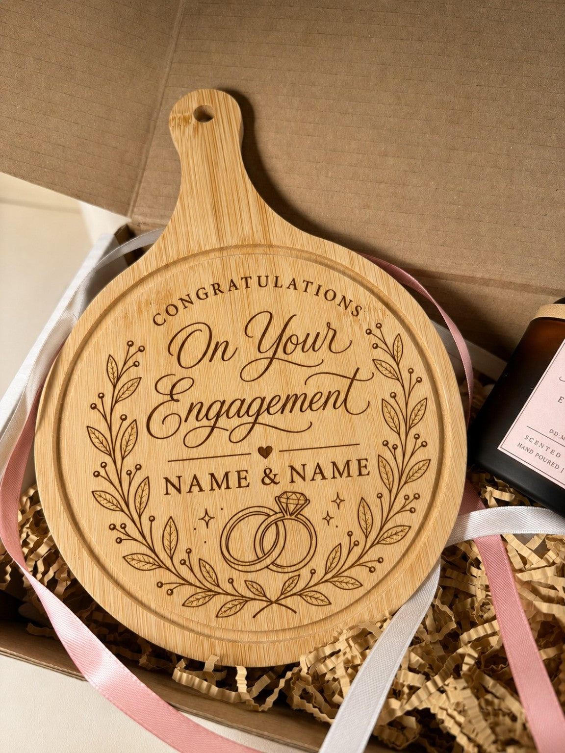Close-up of personalised round engagement chopping board in gift box