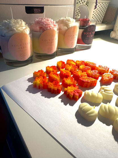 Handmade autumn candles and pumpkin leaf wax decorations being prepared