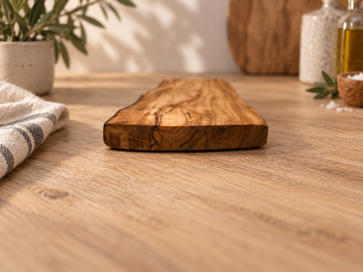 Side profile of personalised olive wood chopping board showing natural thickness