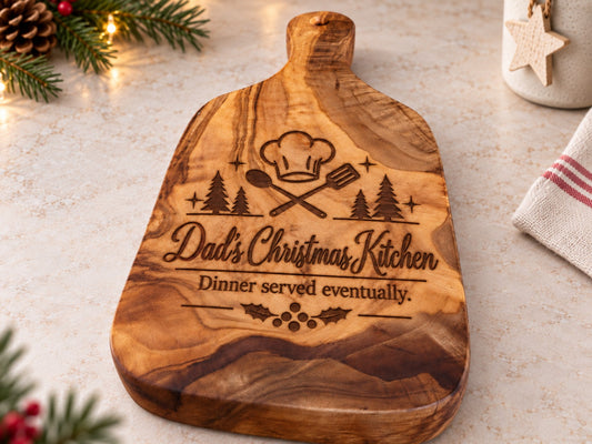 Personalised Christmas olive wood chopping board engraved with Dad's Christmas Kitchen design