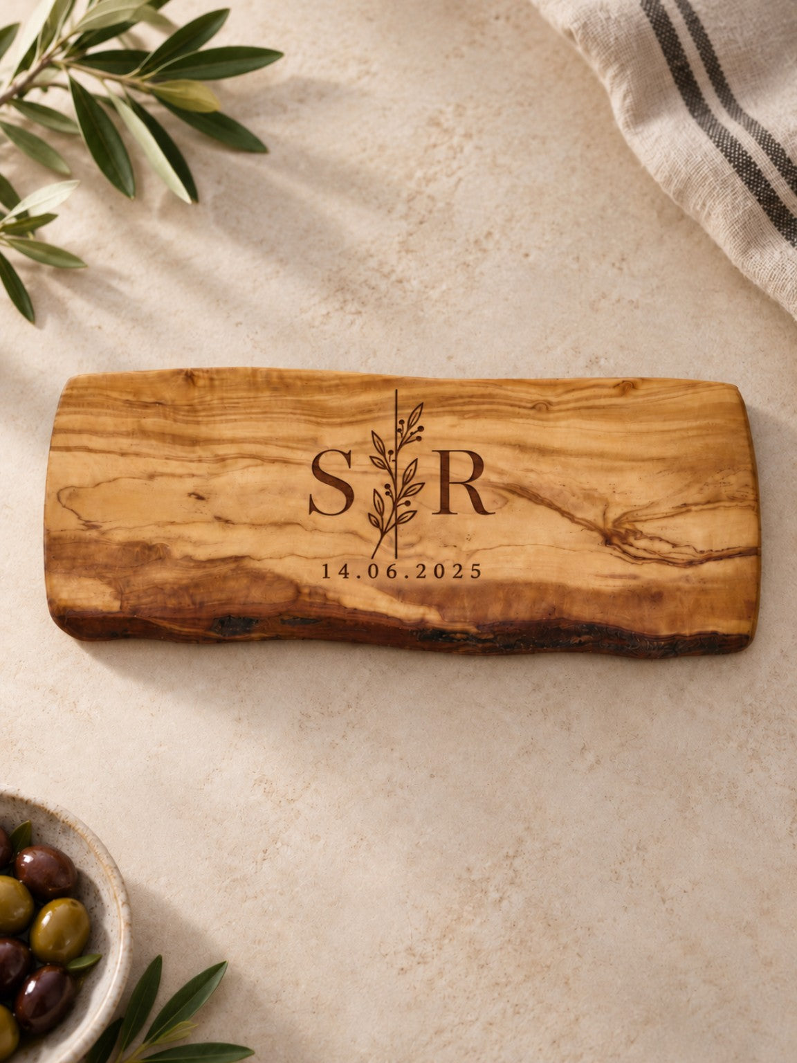 Personalised olive wood chopping board engraved with initials and date