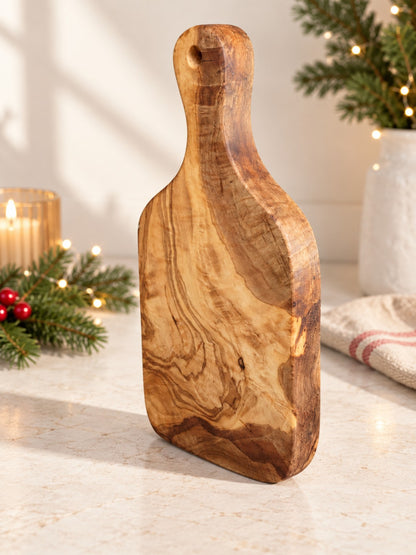 Premium natural olive wood serving board photographed in a festive setting